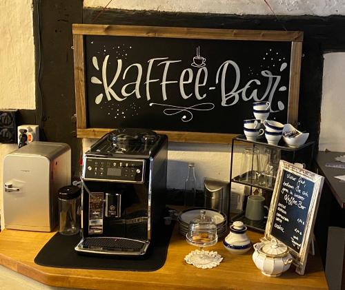 a coffee bar with a coffee maker and a microwave at Haus Buuck - Appartement in Rüthen