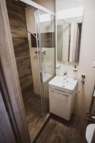 a bathroom with a toilet and a sink and a shower at Orion in Starý Smokovec