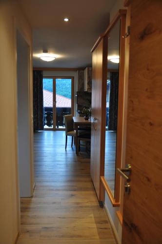 a hallway leading to a dining room with a table at Haus Garz in Weissensee