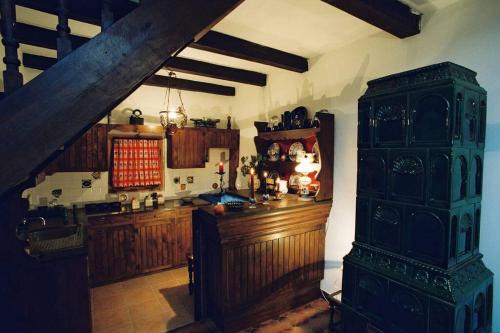 a large kitchen with wooden cabinets and a table at Villa Kornelija in Stari Slankamen