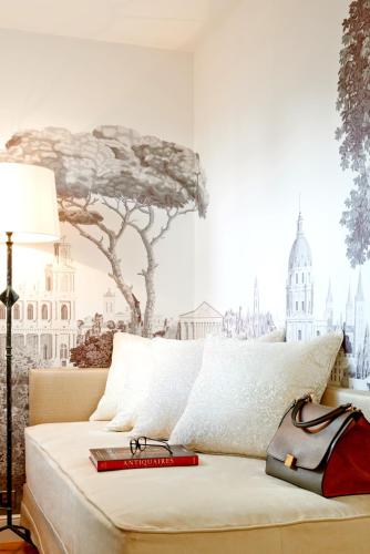 a bedroom with a bed with a tree on the wall at Grand Hôtel Du Palais Royal in Paris