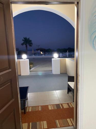 a door to a balcony with a view of a parking lot at Romantic Spa Resort in Fira