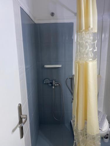 a bathroom with a shower, sink, and toilet at Romantic Spa Resort in Fira