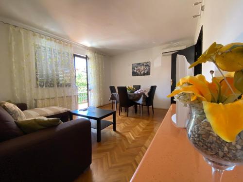 a living room with a couch and a table at Apartments Tajana in Novigrad Istria