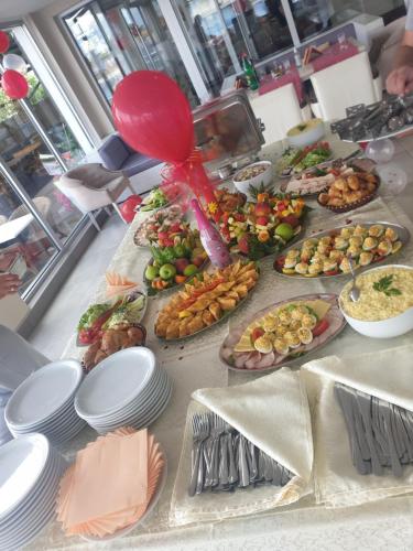 a table with many plates of food on it at Flamingo Resort in Belgrade