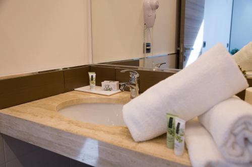 a bathroom with a sink and a mirror at Palazzo Sisto Exclusive Rooms in Catania