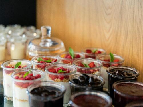 a table topped with small dishes of desserts and a drink at Esquisse Design Hotel in Tʼelavi
