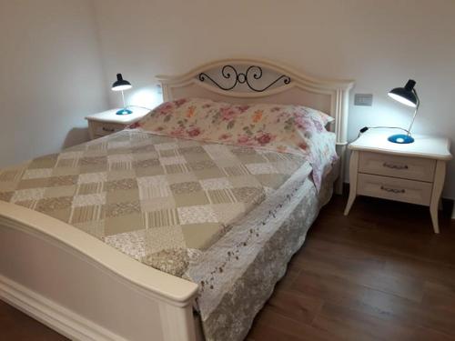 a bedroom with a large bed with two night stands at Via d'acqua Al Mulino -City Center- BO in Bologna