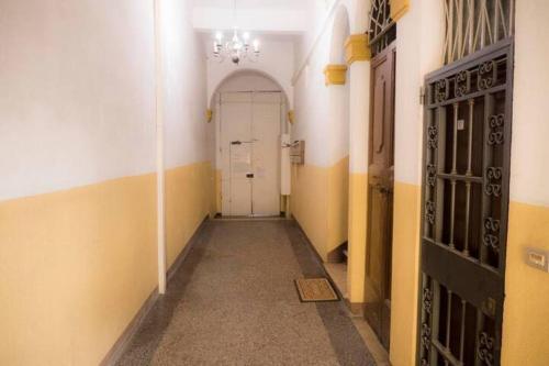 an empty hallway with a white door in a building at Via d'acqua Al Mulino -City Center- BO in Bologna