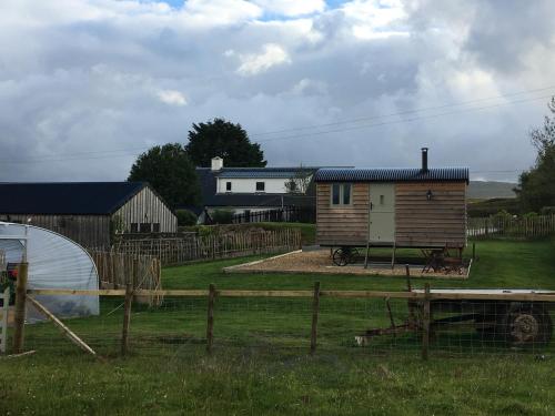 a tiny house in a yard with a fence at 40 Bernisdale - Shepherds Hut in Skeabost