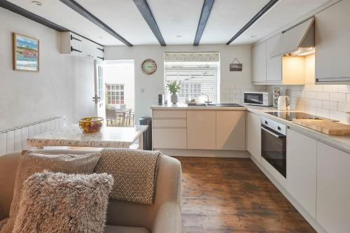 a kitchen with a couch and a table in a room at Host & Stay - Dolphin Cottage 1736 in Whitby