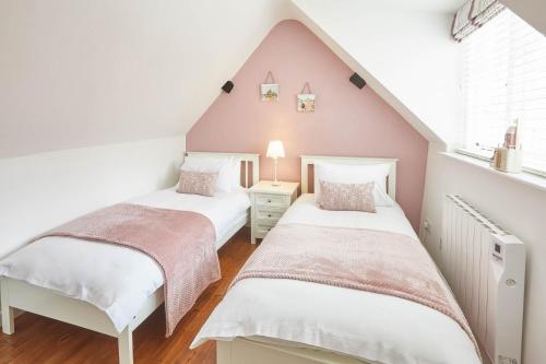two beds in a room with a attic at Host & Stay - Dolphin Cottage 1736 in Whitby