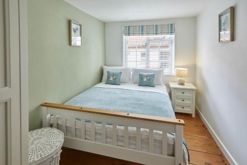 a small bedroom with a bed and a window at Host & Stay - Dolphin Cottage 1736 in Whitby