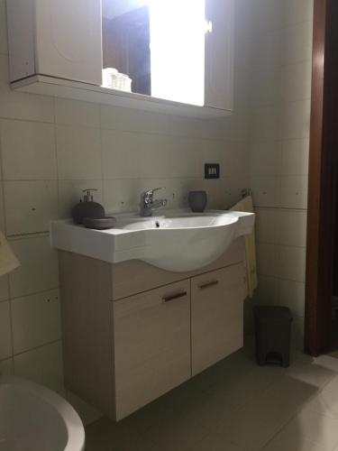 a bathroom with a white sink and a mirror at A casa di Gio in Lecce