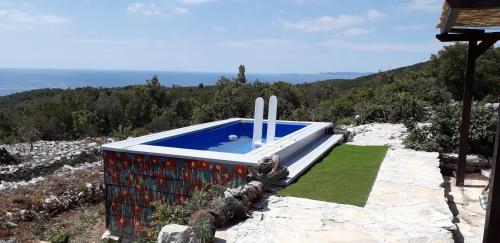 a swimming pool on top of a mountain at Pirate's Nest Stone House in Korčula