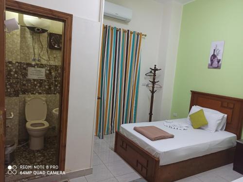 a bathroom with a bed and a shower with a toilet at Golden Star Hostel in Cairo