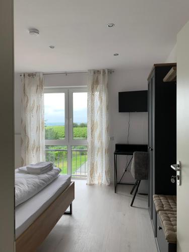 a bedroom with a bed and a large window at HGH - Hotel Garni Helbig in Neustadt an der Weinstraße