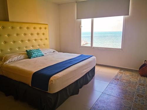 a bedroom with a bed with a view of the ocean at Pent House amazing View beachfront CANCUN in Cancún