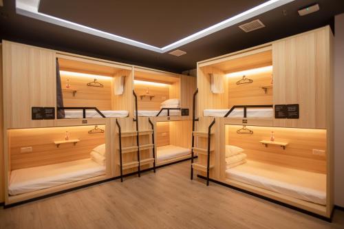 a room with four bunk beds in it at Xi'an Desti Youth Park Hostel Bell & Drum Tower in Xi'an