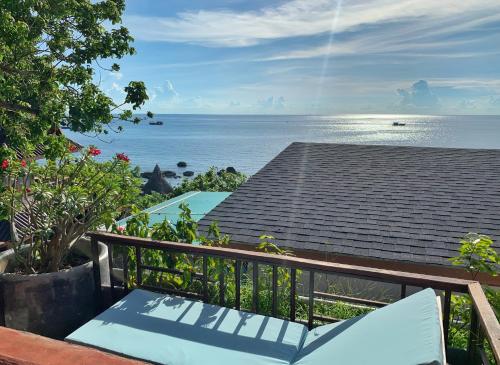 a balcony with a view of the ocean at DD Hut Koh Tao in Koh Tao