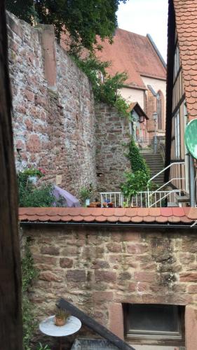 a slice of pizza on a plate on a brick wall at Natur und Neckarblick bei Heidelberg in Hirschhorn