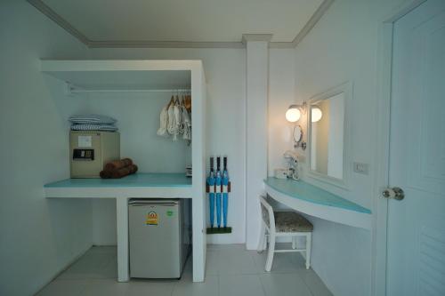 a kitchen with a blue counter and a refrigerator at DD Hut Koh Tao in Koh Tao