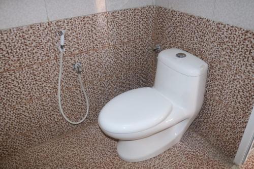 a bathroom with a toilet and a shower at jabal shams moon in Al Ḩamrāʼ