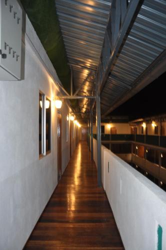 an empty hallway of a building with lights on the ceiling at Joe Fisherman Inn in Pangkor