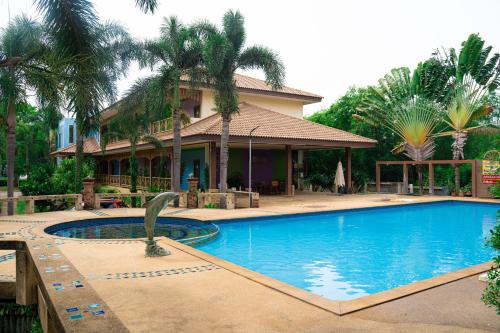 a swimming pool in front of a house at Muak Lek Forest Resort in Muaklek