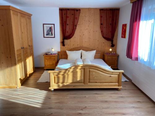 a bedroom with two beds with red curtains at Appartments Hofer in Stumm