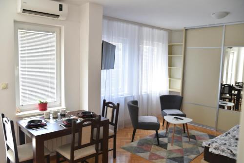 a living room with a dining room table and chairs at City center in Brčko