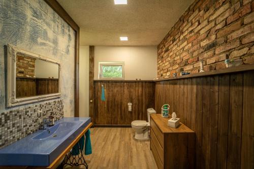 a bathroom with a sink and a toilet at Jaunie Pātari in Bernāti