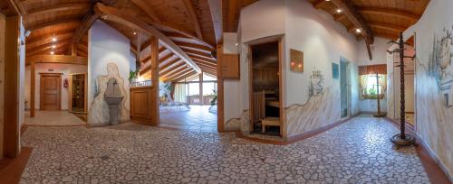 a large hallway with a stone floor and wooden ceilings at Hotel Garni Elisabeth in Zell am Ziller