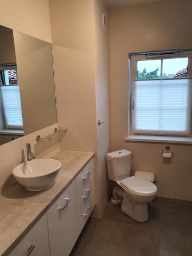 a bathroom with a toilet and a sink and a mirror at Apartament nad Sapiną in Kruklanki