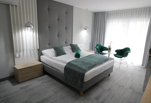 a bedroom with a bed and a table and chairs at Grand Laola Spa in Pobierowo
