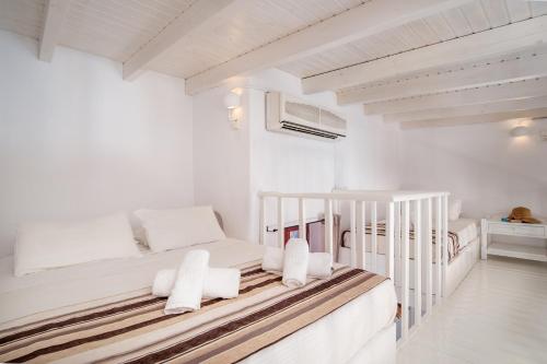 a white room with two bunk beds in it at Atlantis Houses in Halki