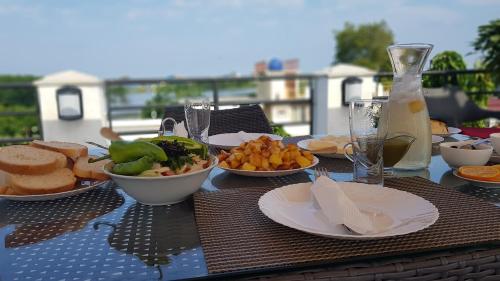 a table topped with plates of food on a table at Twins in Anaklia