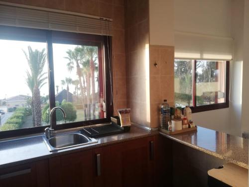 a kitchen with a sink and a window at CN-340 Suites in Estepona