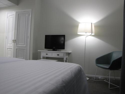 Una televisión o centro de entretenimiento en Hotel Ton