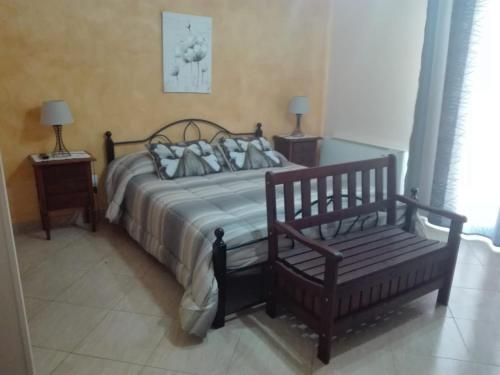 a bed sitting in a bedroom next to a window at THE BEST ROOMS & APARTAMENT - Parcheggia gratis sotto casa ed entra - in Mazara del Vallo