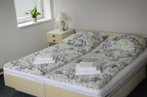 
A bed or beds in a room at Ubytování Goliáš

