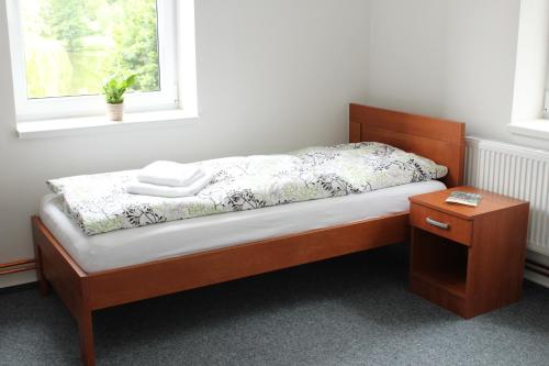 
A bed or beds in a room at Ubytování Goliáš
