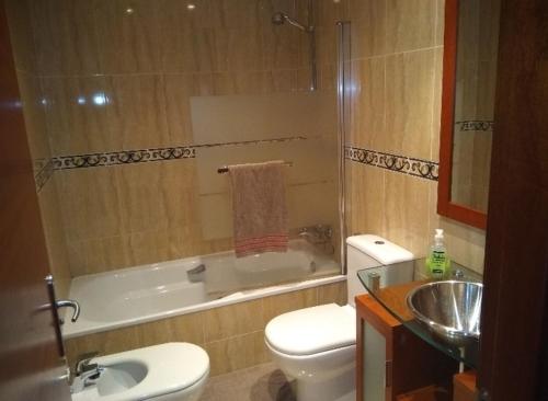 uma casa de banho com um WC, uma banheira e um lavatório. em En el Sella em Cangas de Onís