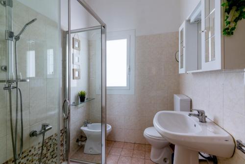 a bathroom with a toilet and a sink and a shower at Apartment In The Heart Of Sanremo in Sanremo