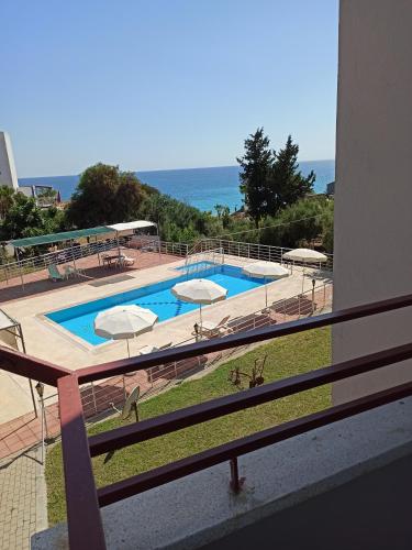 a view of a swimming pool from a balcony at Sercan Apart in Kızılot