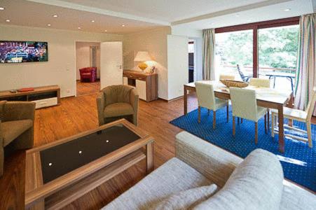 a living room with a couch and a table at Central Hotel-Apart München in Munich