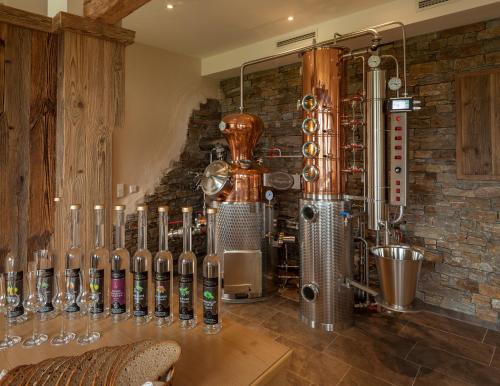 a bar with a row of wine bottles on a wall at Panorama Hotel Gasthof Leidingerhof in Mondsee