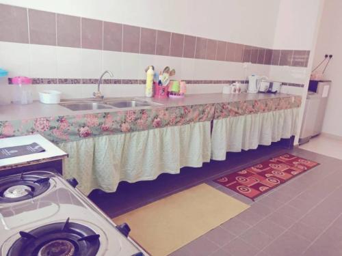 a kitchen with a sink and a washing machine at Pok Su Homestay Balok in Kuantan
