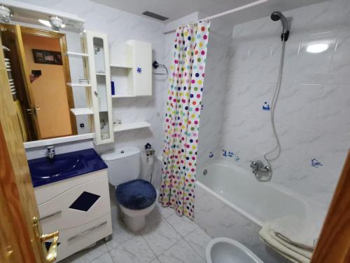 ein Bad mit einem WC und einem Duschvorhang in der Unterkunft Apartamento céntrico, destino Sallent de Gallego in Sallent de Gállego