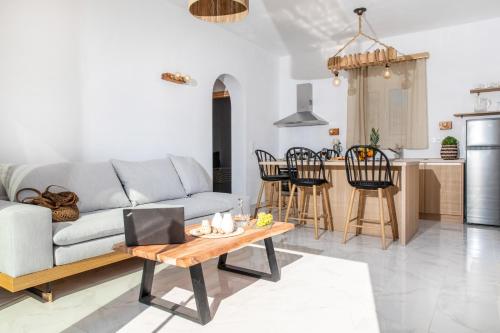 a living room with a couch and a table at Nèsoi Villas Naxos in Naxos Chora